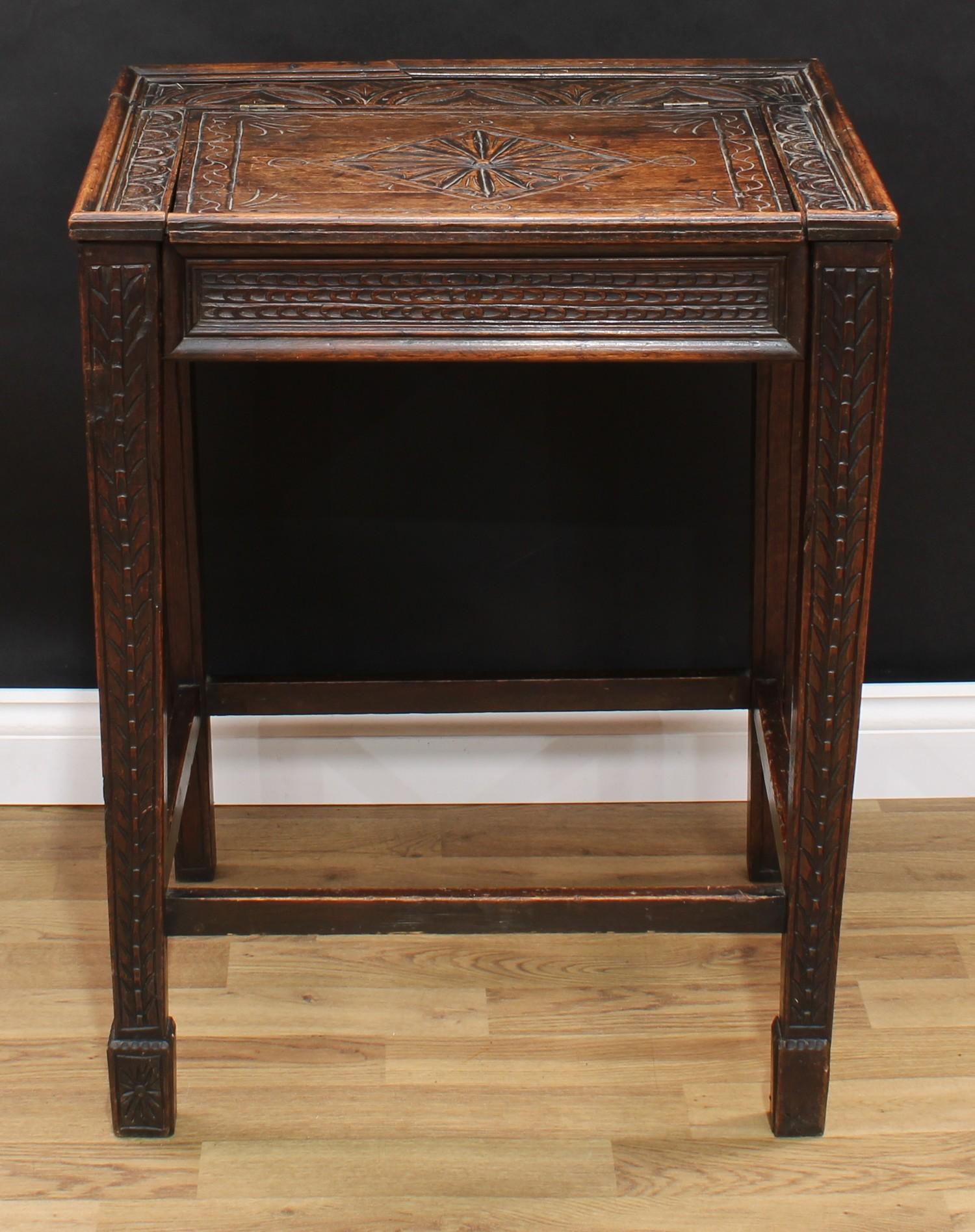 An unusual oak box or bible table, hinged rectangular top incise carved in the 17th century taste,