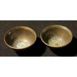 A pair of Chinese bronzed metal bowls, 6cm diameter