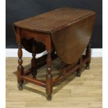 A 17th century style oak gateleg dining table, oval top with fall leaves, turned supports, 72cm