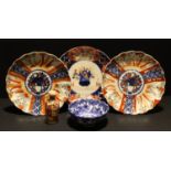 A pair of Japanese plates, decorated in the Imari palette, Meiji period; another similar; a blue and