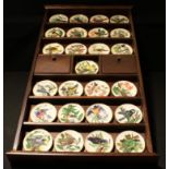 A collection of Franklin porcelain Songbirds of the World miniature plates with wooden display case