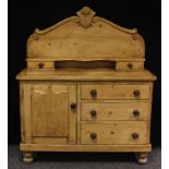A 19th century pine country kitchen dresser, of small proportions, shaped back above a shelf and two