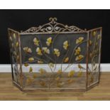 An Art Nouveau style wirework firescreen, scrolling foliate cresting, the panels applied with