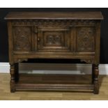 A 17th century style oak low side cabinet, oversailing rectangular top above a central panel door,