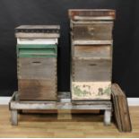 A beekeeping apiary, comprising two hives, one with three brood boxes, one super and a feeder, the