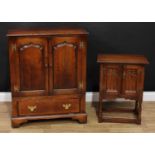 A George III style oak media cabinet, oversailing moulded rectangular top above a pair of arched