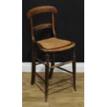 A Victorian child's bar back correction or high chair, cane seat, turned forelegs and stretchers,