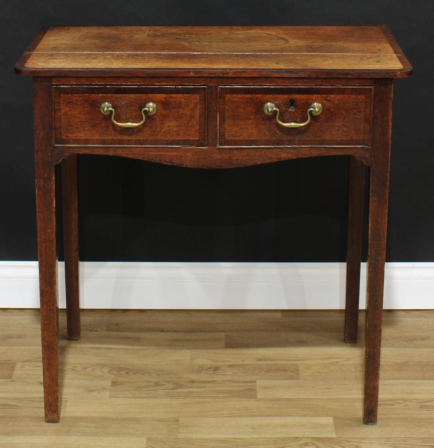 A George III mahogany crossbanded oak side table, oversailing rectangular top above a pair of