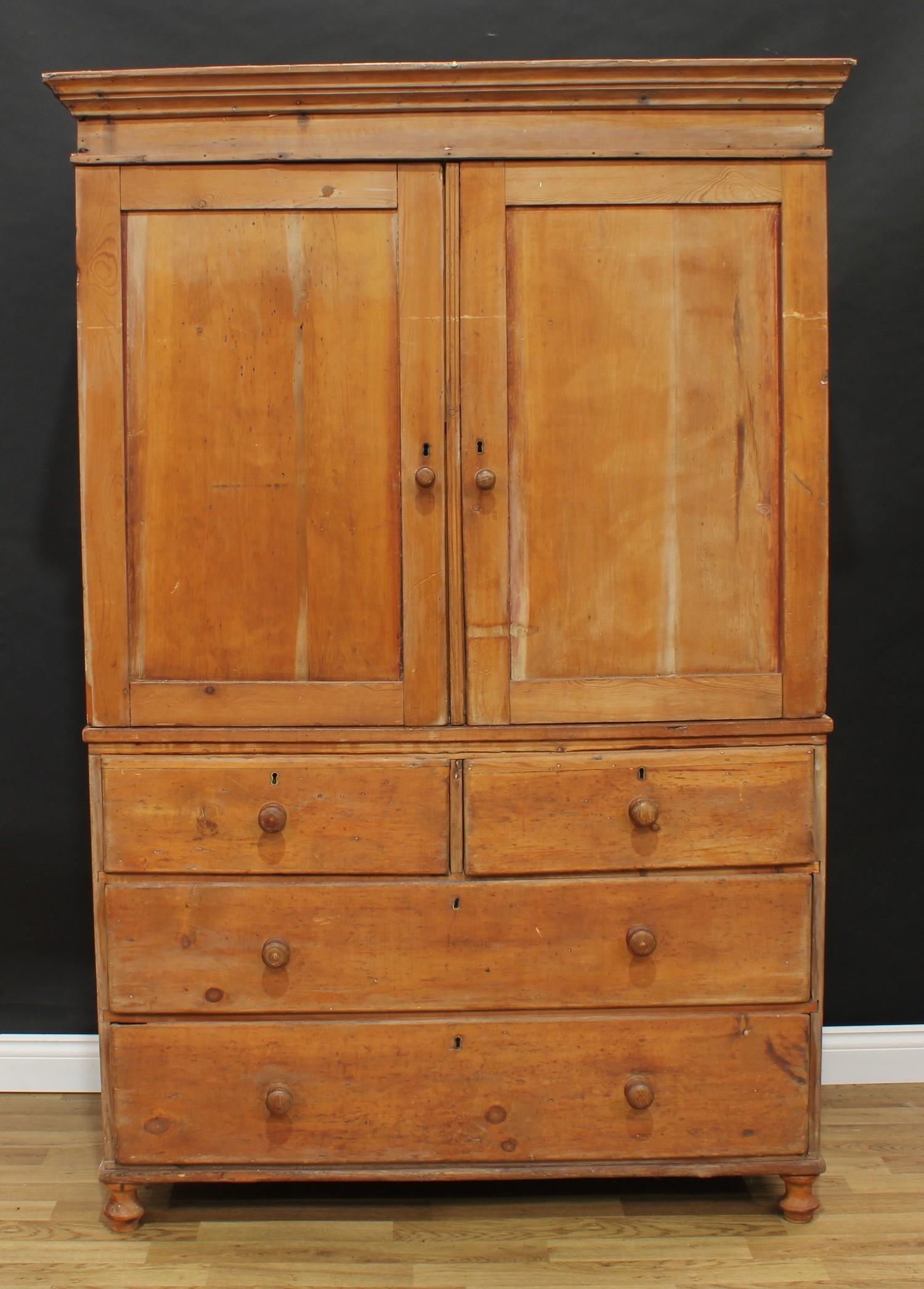 A 19th century pine housekeeper's cupboard or linen press, moulded cornice above a pair of panel