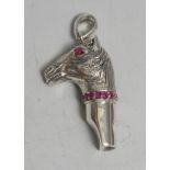 A Sterling silver novelty whistle, as a horse's head, set with rubies, 4.5cm over loop, marked