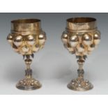 A pair of Continental silver-gilt pineapple cups, in the Renaissance manner, each cast bowl with