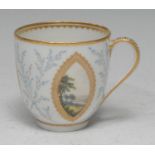 A Derby coffee cup, painted with three navette shaped panels each with polychrome landscape, the