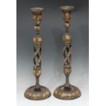 A pair of tall Kashmiri candlestick table lamps, each bell shaped sconce above a knopped open-