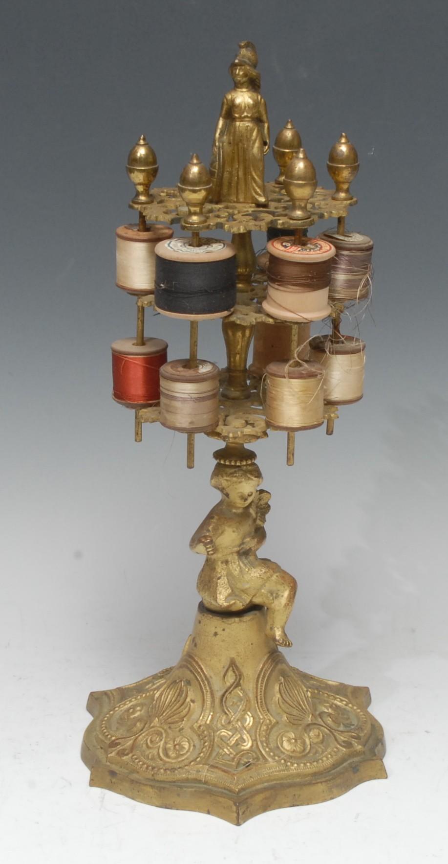 Sewing - a substantial 19th century gilt metal seamstress's cotton reel stand, crested by the figure