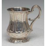 A Victorian silver fluted bell shaped mug, engraved with panels of flowers and scrolling leaves,