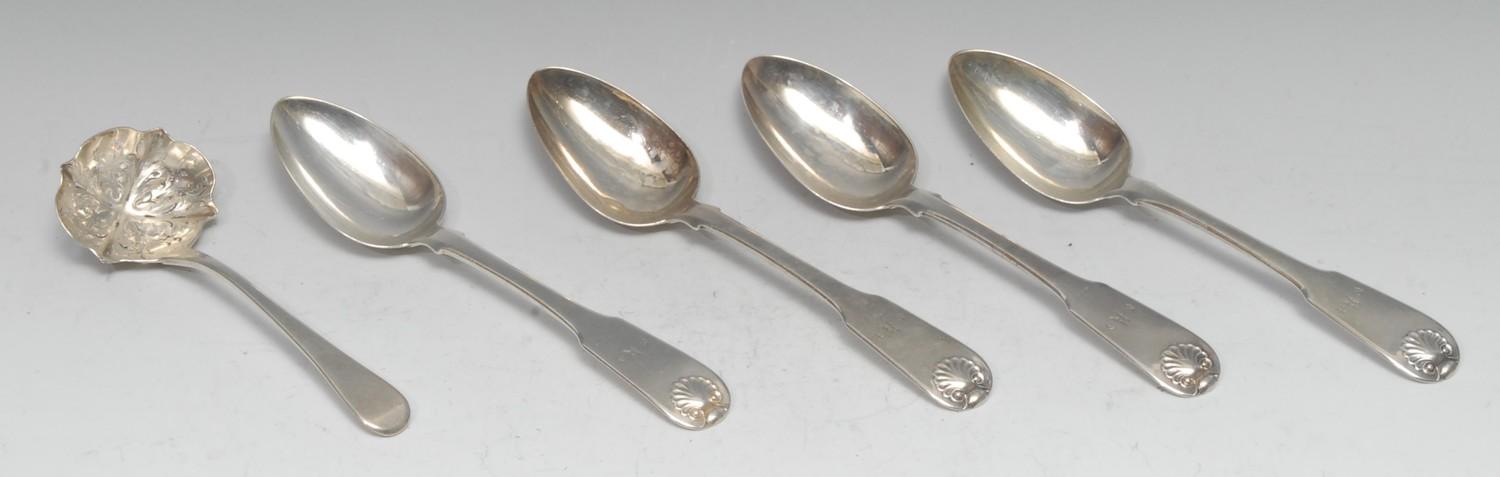 A set of four George III Scottish silver Fiddle and Shell pattern table spoons, Jonathan Millidge,