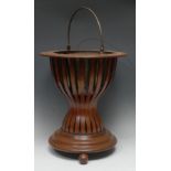 A 19th century Dutch mahogany teesthoff or jardinere, brass swing handle, circular base, outlined