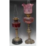 A Victorian Rococo style brass oil lamp, pink glass font, acid etched pink glass shade, 70cm over