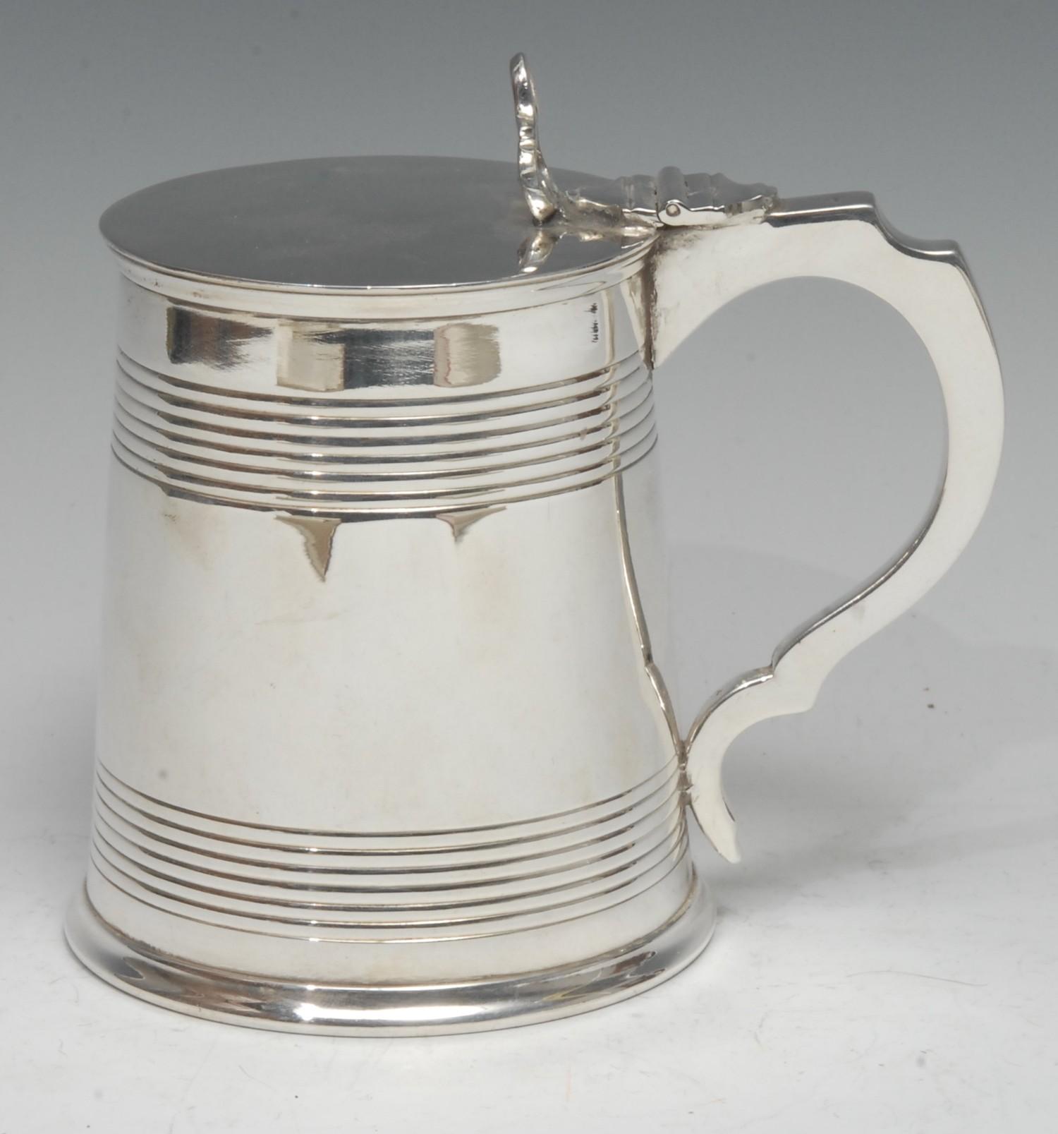 A Victorian E.P.N.S cylindrical pint tankard, of George III design, hinged cover with pierced