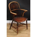 A 19th century elm Windsor elbow chair, hoop back, pierced splat, bowed mid-rail, inswept arm posts,