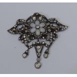 A late 19th century opal and diamond pendant brooch, open scrolling ribbon like floral frame inset