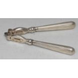A pair of George V silver hafted nut crackers, 16cm long, London 1926