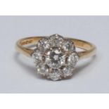 A diamond flower head cluster ring, central round brilliant cut diamond approx 0.30ct, eight claw
