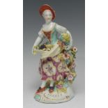 A Derby Patch Mark figure, Allegorical of Summer, she stands wearing a broad brimmed hat, with fruit