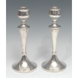 A pair of Elizabeth II silver table candlesticks, tapered pillars, spreading circular bases, 23.