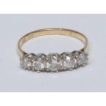 A diamond quintet line ring, linear set with five graduated old brilliant cut diamonds, total