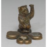 A 19th century novelty brass desk companion, the quatrefoil base centred by an upright bear, the