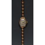 Rolex - a vintage 1930s ladies elongated octagonal 9ct gold bracelet wristwatch, silvered dial,
