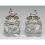 A pair of George IV silver mounted novelty inkwells, each cover cast and applied with a duck, within