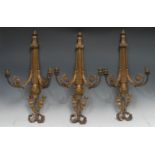A garniture of three Louis XVI Revival gilt-brass two branch wall sconces, each crested by a ribbon,