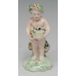 A Derby Patch Mark figure, of a Putti, standing scantilly draped with floral chaplet, holding a