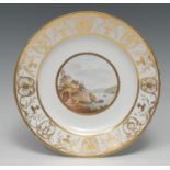 A Derby Named View circular plate, painted by John Brewer, On the Welsh Coast, the rim in gilt
