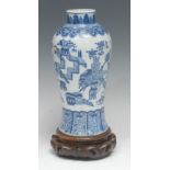 A Chinese baluster vase, painted in tones of underglaze blue with precious objects within lappet