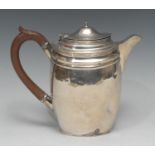 A late Victorian silver tapering oval hot water pot, in the George III taste, engraved with crest of