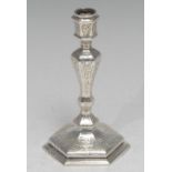 An early Victorian cast silver hexagonal taperstick, of seamed construction, chased overall with