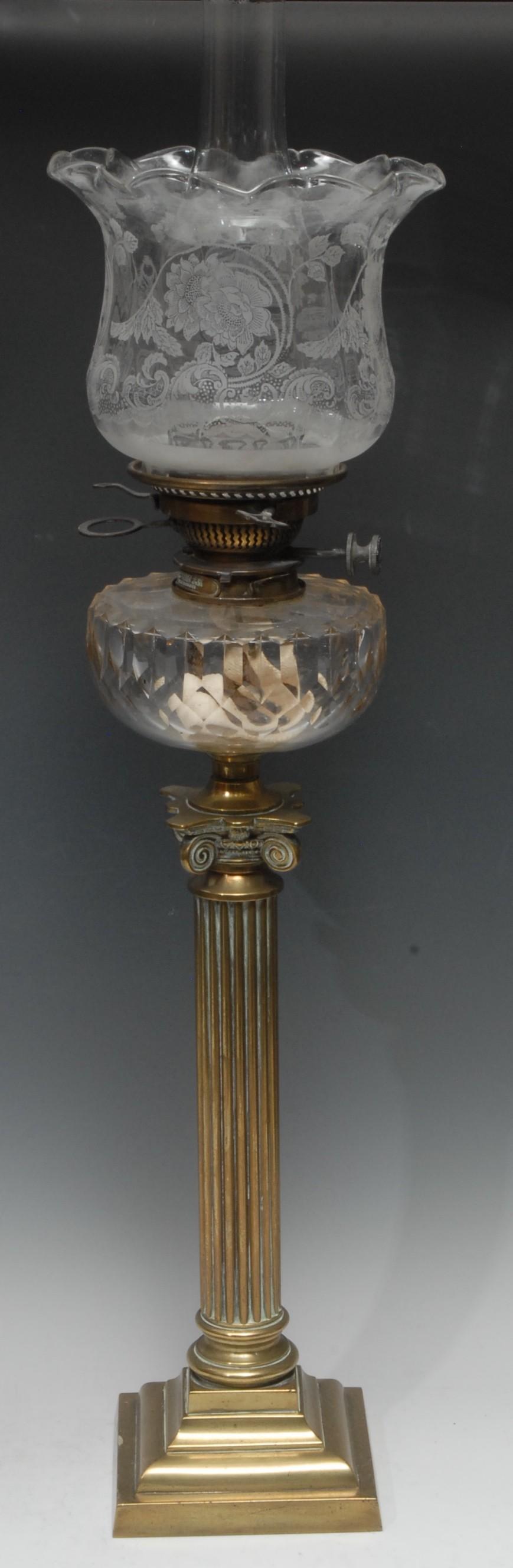 A Hink's Patent oil lamp, clear cut glass font supported by brass ionic column and stepped base,