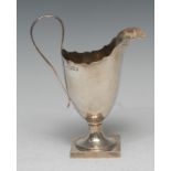 A late Victorian Britannia silver helmet shaped cream jug, of George III design, reeded scroll