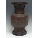 A large Chinese brown-patinated bronze baluster vase, cast in relief with ferocious dragons and