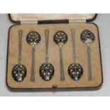 A set of six George VI silver and noir enamel coffee spoons, each bowl decorated to verso with