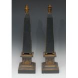 A pair of painted and parcel-gilt softwood obelisk table lamps, stepped bases decorated with