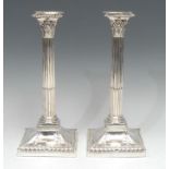 A pair of George III Revival electro-plated stop-fluted Corinthian column candlesticks, gadrooned