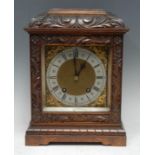 An early 20th century walnut bracket clock, 15cm square brass dial with silvered chapter ring