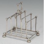 An Edwardian silver five-bar toast rack, in the manner of Christopher Dresser, the square carrying