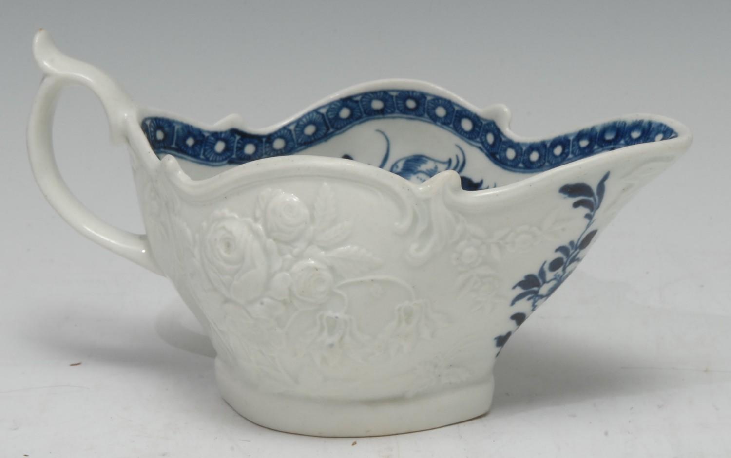 A Worcester Peony pattern sauce boat, the exterior in relief with rose and fuchsias, the interior in