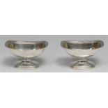 A pair of George III Irish silver boat shaped pedestal salts, gadrooned borders, domed bases, gilt