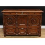 A 'Charles II' oak mule chest, hinged rectangular top enclosing a till, the three panel front